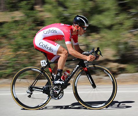 Man riding a bike in cofidis gear
