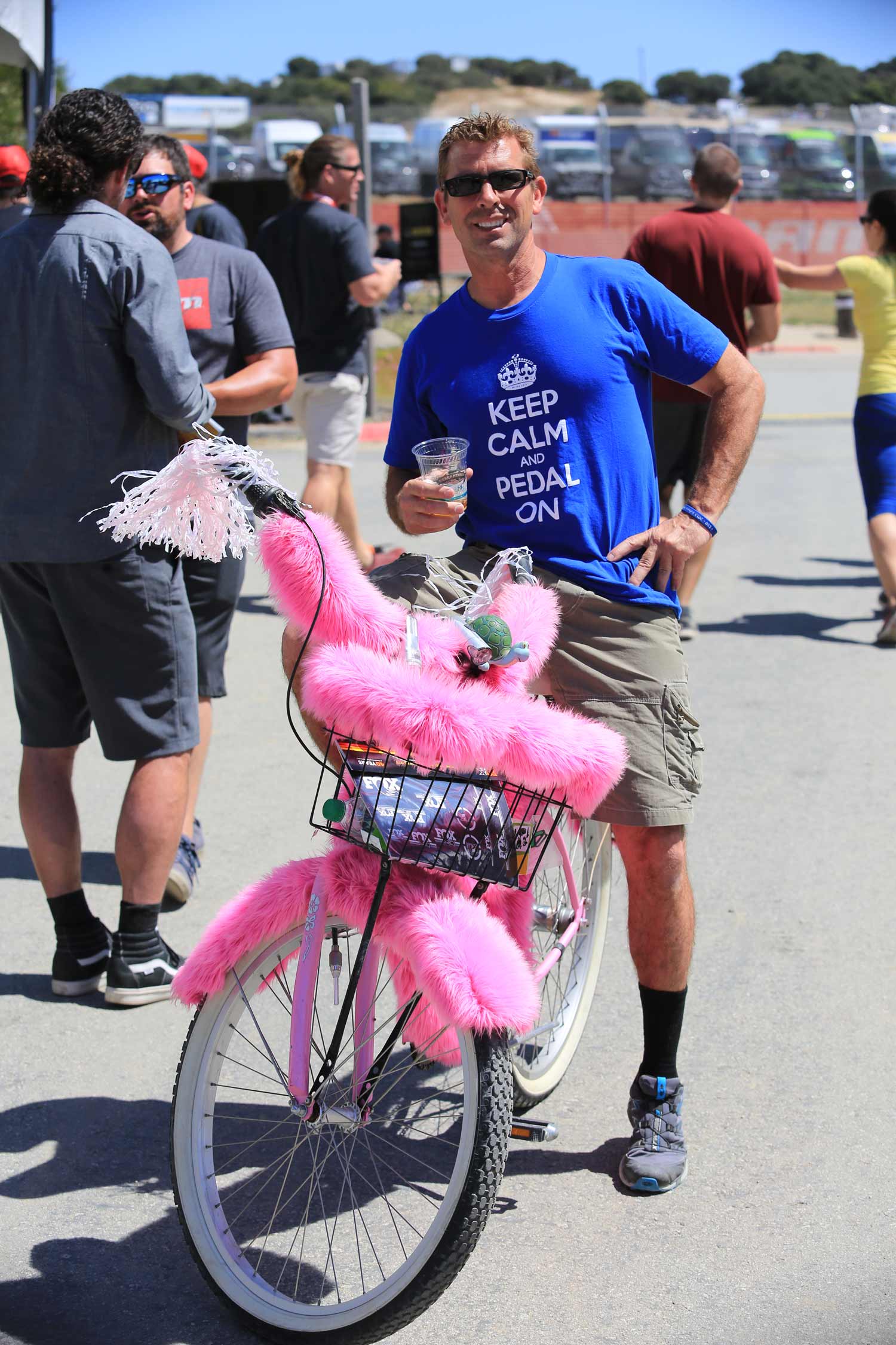 person standing with fuzzy pink bike
