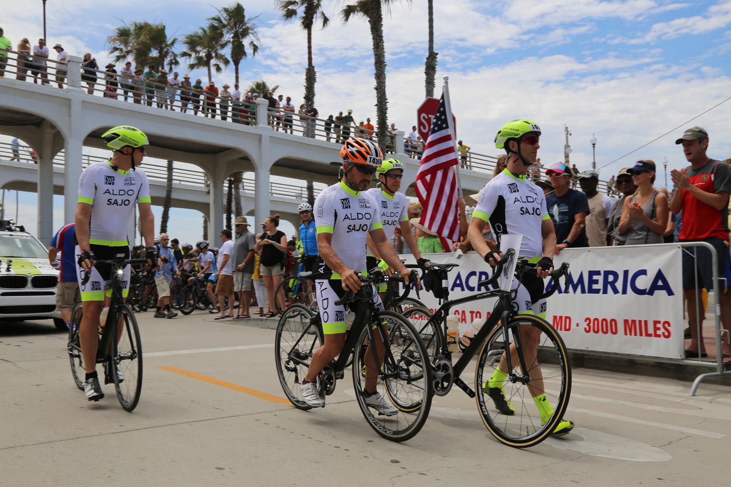 men walk there bikes in a race